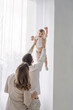 © Nastassia - Happy family having fun at home playing with little son