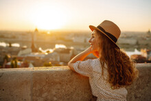 Young Female Tourist  Looking At Panoramic View Of  The City At Sunset. Lifestyle, Travel, Tourism, Nature, Active Life.