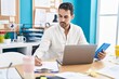 © Krakenimages.com - Young hispanic man business worker using touchpad writing on document at office