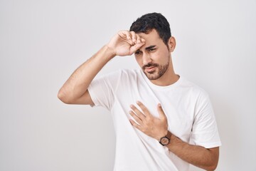 Sticker - Handsome hispanic man standing over white background touching forehead for illness and fever, flu and cold, virus sick