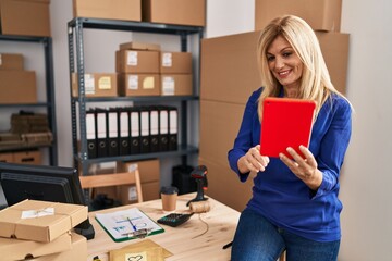 Wall Mural - Middle age blonde woman business worker using touchpad at office