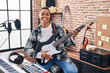 African American Woman Musician Smiling Confident Playing Electrical Guitar At Music Studio
