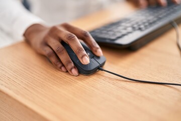 African american woman using computer mouse at office