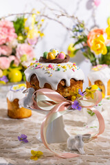 Wall Mural - Festive Easter table setting. Easter cake, Easter Eggs, Flower arrangements and home decorations for holiday.