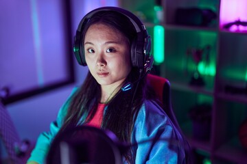 Poster - Young chinese woman streamer playing video game using computer at gaming room