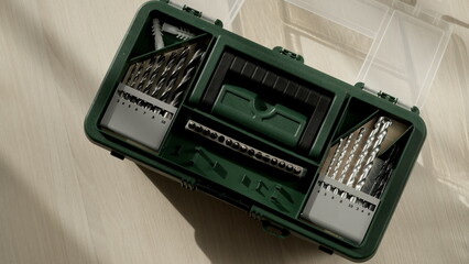 Top down green tool case. Carpenter at work, tools for drilling holes close-up. worker takes tools to work.