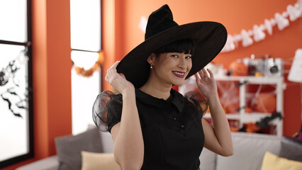 Sticker - Young chinese woman wearing witch costume having halloween party at home