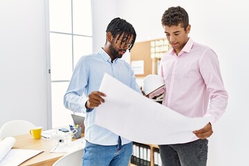 Wall Mural - Two men architect workers looking blueprint standing at architecture studio