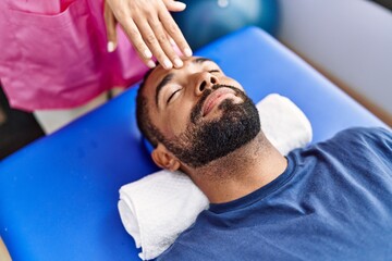 Sticker - Man and woman wearing physiotherapist uniform having reiki session at physiotherpy clinic