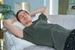© Евгений Шемякин - Young handsome man is rest sleep at home in living room on couch or sofa with his eyes closed. Daytime sleep