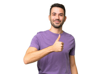 Wall Mural - Young handsome caucasian man over isolated background giving a thumbs up gesture