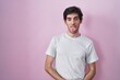 © Krakenimages.com - Young hispanic man standing over pink background sticking tongue out happy with funny expression. emotion concept.