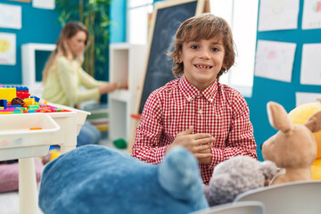 Poster - Teacher and toddler playing at kindergarten