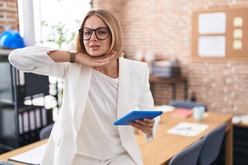 Poster - Young caucasian woman working at the office wearing glasses cutting throat with hand as knife, threaten aggression with furious violence