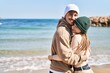 © Krakenimages.com - Mand and woman couple smiling confident hugging each other at seaside