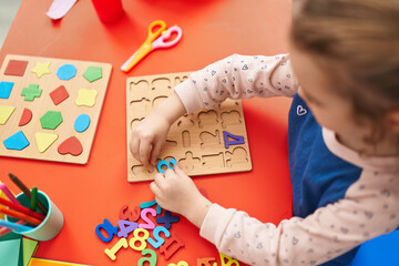 Poster - Adorable blonde girl playing with maths puzzle game sitting on table at kindergarten