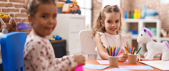 Sticker - Two kids preschool students sitting on table drawing on paper at kindergarten