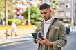 © Krakenimages.com - Young hispanic man using touchpad at park