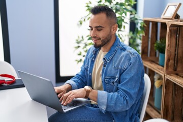 Sticker - Young hispanic man using laptop sitting on table at home