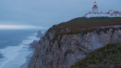 Wall Mural - beautiful dark evening panorama with farol lighthouse in the atlantic ocean at cape cabo da roca, po
