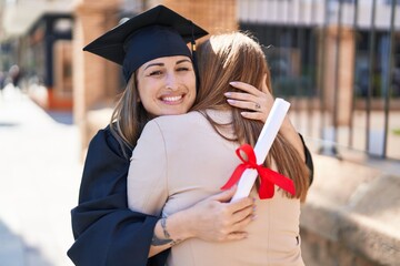 Poster - Mother and daughter hugging each other celebrating graduation at university