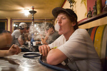 A Young Man Smokes Hookah At Zaina In Downtown Seattle, Washington.