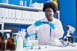 © Krakenimages.com - Young african american woman scientist make photo by the smartphone at laboratory