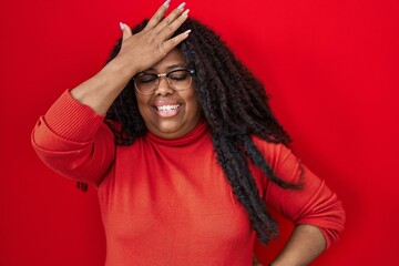 Sticker - Plus size hispanic woman standing over red background surprised with hand on head for mistake, remember error. forgot, bad memory concept.