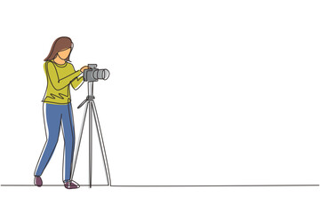 Wall Mural - Continuous one line drawing female photographer taking photos using professional equipment set. Woman with camera making pictures. Studio photo equipment. Single line draw design vector illustration