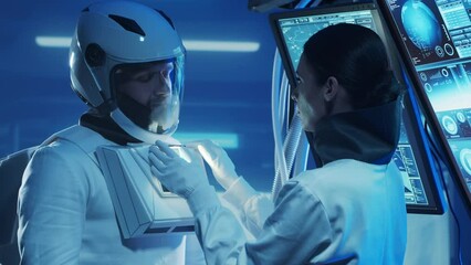 Wall Mural - Team of astronauts in a space suits aboard the orbital station. A crew of cosmonauts preparing the spacesuit. Man and woman in space. Galactic travel and science concept.