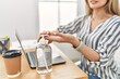 © Krakenimages.com - Young chinese woman using hand sanitizer gel working at office