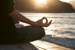 © erika8213 - Woman meditating outdoors at sunset