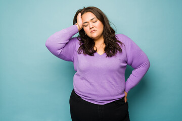 Wall Mural - Tired latin woman having a bad headache