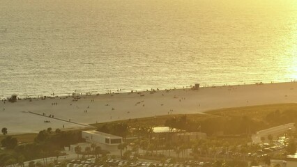 Canvas Print - View from above of evening Siesta Key beach with white sands full of tourists in Sarasota, USA. Many people enjoing vacation time swimming in Mexica gulf water and relaxing on warm Florida sun