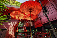 Exterior Details Of Traditional Wooden House With Decorative Umbrellas In The  Garden In Bangkok, Thailand