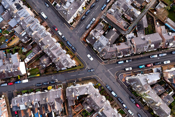 Wall Mural - Aerial view directly above the rooftops and road junction in a typical English suburban neghbourhood