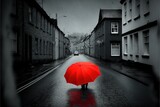 Fototapeta Do przedpokoju -  a person walking down a street holding an umbrella in the rain with a car parked on the side of the road behind them and a building.  generative ai