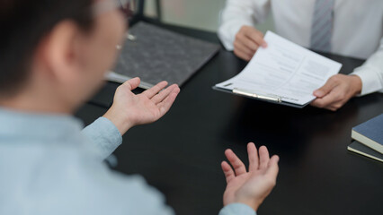 Wall Mural - Examiner reading a resume during job interview at office.