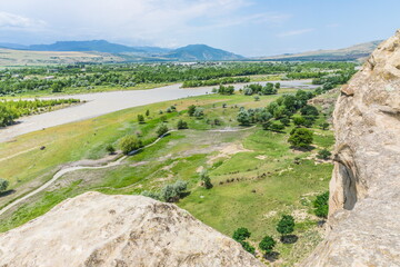 Wall Mural -  stones on the high rocky left bank of the Mtkvari River, Uplistsikhe, Georgia