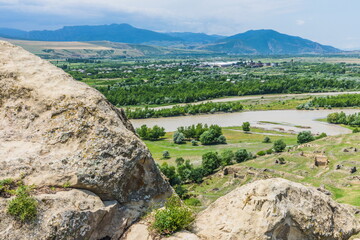 Wall Mural -  stones on the high rocky left bank of the Mtkvari River, Uplistsikhe, Georgia