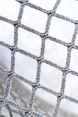 hockey goal net. hockey net close up vertical photo, photo with shallow depth of field.