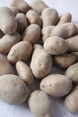 Close up of slice of raw potato in a bowl 