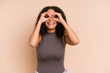 © Asier - Young african american curly woman isolated showing okay sign over eyes