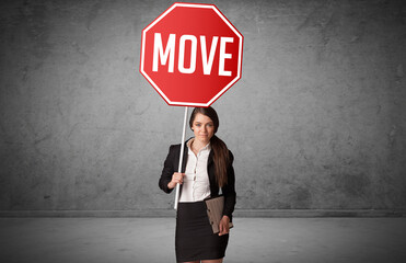 Young business person holding road sign