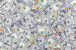 A heap of one hundred US dollar bills as a background, business concept