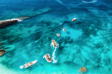 Wall Mural - Aerial view of motorboats off the coastline in a summer. Top view from drone of the blue sea. Beautiful seascape