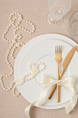 Wall Mural - Festive wedding, birthday table setting with golden cutlery and porcelain plate. Empty plate mockup. Party menu template. Flat lay, top view