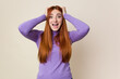 © Asier - Young red hair woman isolated screaming, very excited, passionate, satisfied with something.