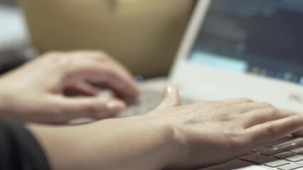 Web developer at work. Woman's hands typing and coding software on the laptop