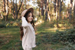 © Andriy Medvediuk - Portrait of beautiful little girl in hat looking at camera and smiling. Happy cute child having fun in park outdoors, enjoying childhood, be in good mood. Dream of child and happiness of child